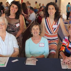 Boothbay Harbor Memorial Library representatives welcomed 35 Maine authors July 27 to Boothbay Railway Village. Pictured, sitting, from left, event volunteers Sharon Pulkinen, Cheryl Blaydon,Gloria Taliana. Standing, from left, Library Executive Director Joanna Breen, and Assistant Director Desiree Scorcia. BILL PEARSON/Boothbay Register