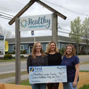 First National Bank’s Damariscotta Branch Manager, Jessica Day, left, presenting a check for $750.00 to Healthy Lincoln County. Courtesy photo