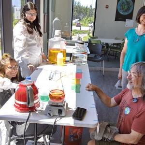 From left, Bigelow Laboratory’s Kate Smith and Kristin Heidenreigh talk ocean science with visitors Renee and Michael Zeleny of Rice, Minnesota. JANE CARPENTER/Boothbay Register