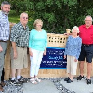 Several civic-minded people worked to find a location for a new bottle bin. Boothbay Civic Association and the Landscape Committee reached an agreement with local businessman Paul Coulombe to place it near the Boothbay Common’s new restrooms. Pictured, from left, Town Manager Dan Bryer, Tom Nickerson of the Boothbay Landscape Committee, BCA President Dawn Gilbert, Boothbay BCA member Joan Rittall, and Coloumbe. Courtesy photo