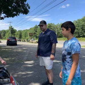 Boothbay Harbor’s Kelley Coady talks helmets outside Miss Wiscasset Diner Aug. 23 with shoppers and past customers Ryan Daniels and son Ismael Martinez, 12, of Westport Island. SUSAN JOHNS/Wiscasset Newspaper