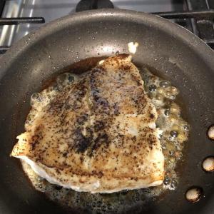 The halibut, cooked in oil with capers, salt and pepper, with a pat of butter, is almost done. Lisa Orne Hallinan photo