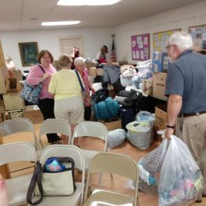 After the Aug. 1 meeting, attendees sorted donations for the asylum seeker families in Portland and elsewhere before transport to Portland. Courtesy of Mal Gormley