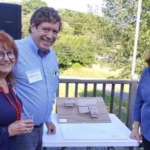 From left, Susan Wilson, project chair, Dr. Chip Teel, founder of ElderCare Network Lincoln County, and Susan Brackett, who led the effort to save the Kenniston Hill Inn, stand next to a model of the proposed Kenniston House campus. JANE CARPENTER/Boothbay Register