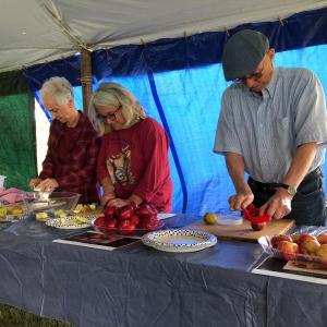Volunteers wait to slice the apples for tasting. JENNY BENNETT/Boothbay Register