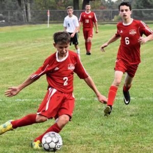 Freshman Payton Blagdon with the ball got the goal that sent the Sept. 11 game with Carrabec into overtime. Also shown is Payton’s older brother Chance Blagdon. PHIL DI VECE/Wiscasset Newspaper