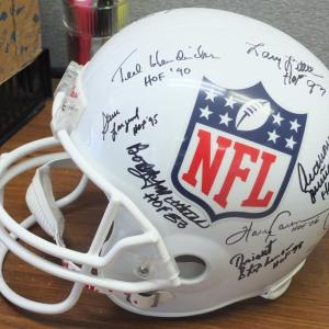A helmet autographed by 15 Pro Football Hall of Famers is one of dozens of sports memorabilia and other donated items available at the 29th Boothbay Charities Classic Sept. 27 and 28. BILL PEARSON/Boothbay Register