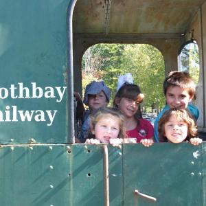 Family Harvest Days had lots of games and rides, but these kids loved checking out a train car Sept. 21 at Boothbay Railway Village. BILL PEARSON/Boothbay Register
