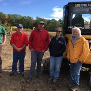 A community effort began last week to prepare Clifford Park for future expansion. Pat Farrin, and his crew began leveling off a back field at the park. Pictured, from left, are Boothbay Town Manager Dan Bryer, Tommy Nickerson, Kipp Farrin, Boothbay Region Water District Watershed Protection Manager Sue Mello, and Pat Farrin. BILL PEARSON/Boothbay Register