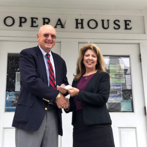 Betsey deGroff presents a check to Ken F-Fitch, a member of the Opera House board, representing the proceeds from the Sept. 15 benefit concert held at the Congregational Church. Skip Simonds photo