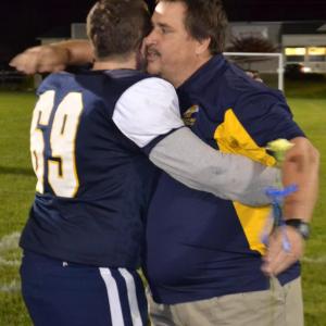 Boothbay center Dwight Lucas receives a hug from Coach Ed Crocker Oct. 11 during Seniors Night at Sherman Field. BILL PEARSON/Boothbay Register