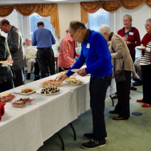 Attendees of The Lincoln Home thank you party gather around the food table. Kim Traina photo
