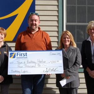 Presenting a check from First National Bank are, from left, First National Bank’s EVP, Chief Administrative Officer Susan Norton, Boothbay Lights Committee chair Michael Maxim, Boothbay Harbor Town Manager Julia Latter, and VP, branch manager, Brenda Blackman. Courtesy photo