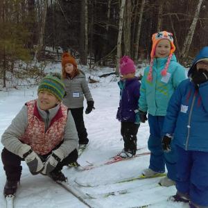 Cross-country skiing coach Kristy Houghton with students. Courtesy of Midcoast Conservancy