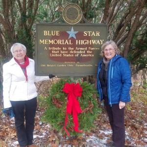 Sue Hochstein, left, of Pemaquid Chapter DAR, and Linda Redman, chairman of The Garden Club Federation of Maine Blue Star Committee, place a wreath at the Blue Star marker in Newcastle. Courtesy photo