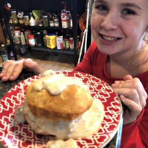 Granddaughter Lilly with a biscuit and sausage gravy. Lisa Orne Hallinan photo