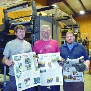 After working all night to complete the installation of two new color units, The Lincoln County News publisher Chris Roberts, center, and associate publishers John Roberts, left, and Allan Roberts hold copies of the March 30, 2017 edition. J.W. Oliver photo