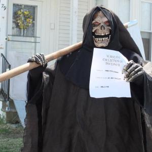 The “Grim Reaper,” aka Linc Sample, makes an appearance April 29 on Townsend Avenue in Boothbay Harbor with a warrant for collection for the Maine economy. BILL PEARSON/Boothbay Register
