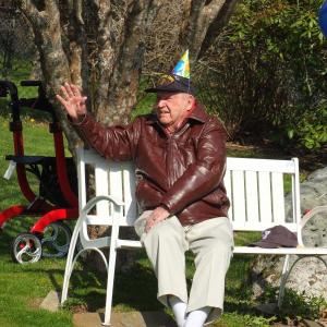 John Druce of Boothbay Harbor waves to a parade of well-wishers who wished him a Happy Birthday May 15 as he sat and watched them. BILL PEARSON/Boothbay Register