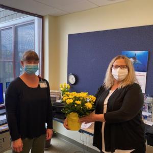Lauri Andrews, RN, receives a beautiful flower from Holly Stover, president of the Boothbay Region District Nursing Association, as part of National Nurses Week. Courtesy photo