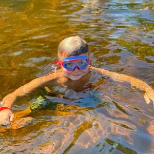 Kolby keeps cool on a hot day in Knickerbocker Lake. Courtesy of BRYMCA