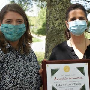 Kate Martin, left, director of Healthy Lincoln County, accepts the 2020 Coulombe Center for Health Improvement Innovation Award from AnniPat McKenney, manager of the Center. Courtesy of LincolnHealth