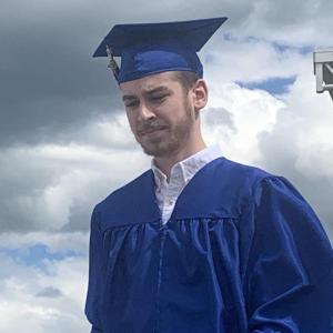 A graduate heads back to a car after his turn onstage getting his diploma. SUSAN JOHNS/Wiscasset Newspaper