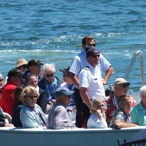 Visitors from the American Constitution arrive on board a tender in 2018. File photo