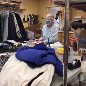 Betty Goulette hard at work sorting donations in the back room of the Thrift Shop. Courtesy of Laura Zajdel