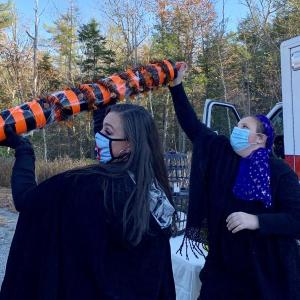 Wiscasset’s interim EMS chief Erin Bean, left, and daughter Phoebe Middleton pass treats through a tube to a carload of trick or treaters Saturday afternoon. SUSAN JOHNS/Wiscasset Newspaper