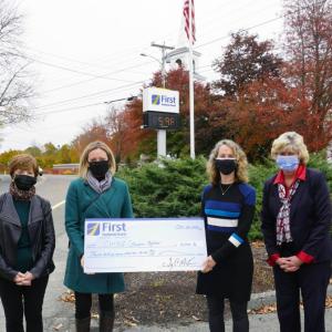 Garden’s Aglow: First National Bank’s EVP, Chief Administrative Officer, Susan Norton, Business Development Officer, Alyssa Allen, Coast Maine Botanical Gardens, President & CEO, Gretchen Ostherr and VP, Branch Manager, Brenda Blackman presenting a $5,000 check from First National Bank. Courtesy photo