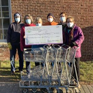 Ecumenial Food Pantry volunteers receive shopping carts and a financial donation from Walker Reed of Rising Tide. From left are Doug Merrick, Cindy Freese, Linda Sandefur, Bill Bausch, Walker Reed, Ellen Dickens. Courtesy photo