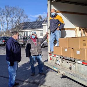 Rotarians, from left, Bob Pike, Vic Taylor and Tom Churchill, unload food boxes Thursday, Dec. 3 in Boothbay Harbor. Courtesy photo