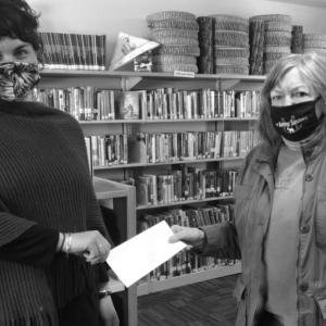 Joanna Breen, left, director of the Boothbay Harbor Memorial Library, accepts the donation from Friend of the Library President Ann Kelley. Courtesy photo