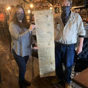 Marc Brewer and Thistle Inn general manager Sonya Dearborn hold the poem about Leonie Greenwood Adams. Brewer recently donated the poem to the Boothbay Harbor establishment. KEVIN BURNHAM/Boothbay Register