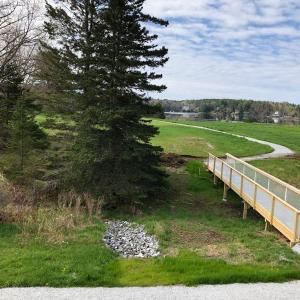 Universal access trail at Oak Point Farm. The extension will provide an option to take a left at the bridge and loop around the freshwater pond, which includes a land bridge between the pond and Hodgdon Cove. Courtesy of BRLT