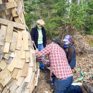 Coastal Maine Botanical Gardens volunteer Louise Cowan assists horticulturist Jenn Dunlap and a member of artist Thomas Dambo’s crew in preparing a new experience planned for this month. Courtesy photo