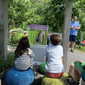 Puppet show under the grape arbor, with the story, "The Blue Jay and the Owl," Carried out by volunteer youth education steward Zoe Curtis and Youth Programs Educator Bridget VerVaet. LILLY CURTIS/Boothbay Register