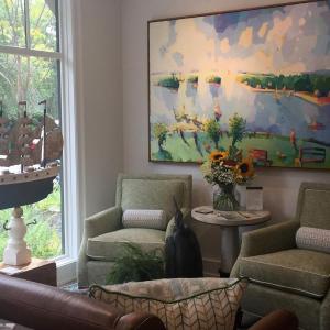 This living room features a color palette drawn from this colorful Henry Issacs painting. LISA KRISTOFF/Boothbay Register COVE by Knickerbocker Group