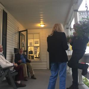 Artists Tony van Hasselt, left, and Terry Seaman (also the gallery owner) and guests sat outside for a spell. LISA KRISTOFF/Boothbay Register