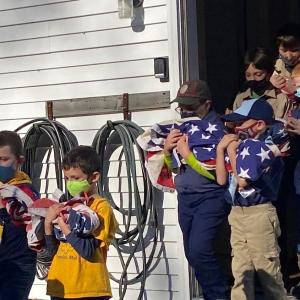 Boy Scout Troop 213 in a procession to dispose of retired American flags by burning at the Nov. 11 ceremony at American Legon Post 36 in Boothbay. JOSEPH CHARPENTIER/Boothbay Register