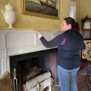 Floral designer Laura Tibbetts takes measurements of the Nickels-Sortwell House rooms in preparation for creating floral displays. Marketfest photo