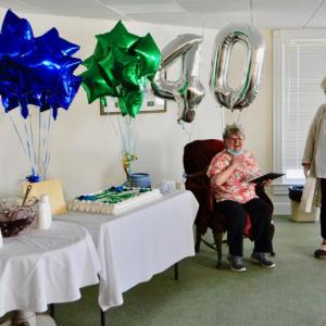 Barbara Follett is celebrated with much love from her Lincoln Home family. Here, Executive Director Lorrie Winslow presents her with gifts of appreciation. Kimberly Traina photo