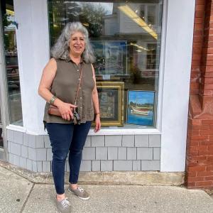 Marylou Lazos stands next to her piece on display at Boothbay Region Art Foundation. ISABELLE CURTIS/Boothbay Register