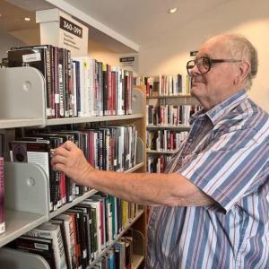 Richard “Dick” Brown looks over selections at the Boothbay Harbor Memorial Library. Courtesy of Joanna Breen
