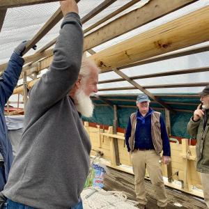 From left, some of the volunteers of Maine’s First Ship and the Virginia, Brunswick’s Paul Cunningham, Topsham’s Jim Amundsen and Brunswick’s Paul King talk with a longtime donor, Alna’s Fred Bowers, far right, when he stopped by the ship Jan. 18 in Wiscasset where it is wintering. SUSAN JOHNS/Wiscasset Newspaper