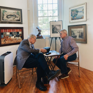 Maine State Historian Earle G. Shettleworth, Jr. (left) and Peter Fogg prepare to run an audiotape that vividly recollects the intelligence and energy of the Maine Art Gallery's founder, Mildred Burrage. Courtesy of the gallery