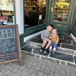 Oscar Mirabile, 6, and brother Louie, 1, sit on the steps leading into Woodsong Market at 93 Townsend Ave. Courtesy