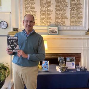 Southport native Charles Britton, pen name C.W. Wells, poses with his new book at Boothbay Harbor Memorial Library. ISABELLE CURTIS/Boothbay Register