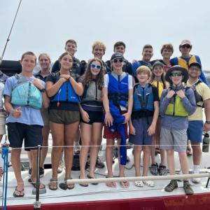 SYC Sailing Program students with Navy Midshipmen on Wahoo. Courtesy of Cecily Walsh